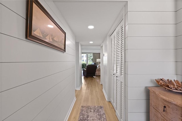 hallway featuring light wood finished floors and recessed lighting