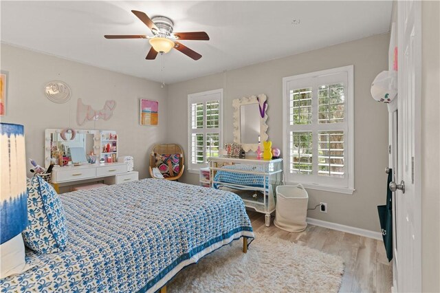 bedroom with light wood-type flooring and ceiling fan