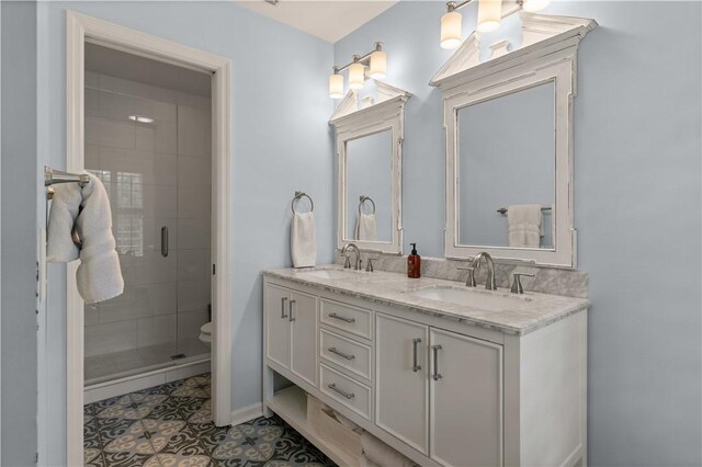 bathroom featuring tile patterned floors, toilet, vanity, and walk in shower