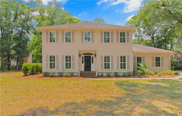 colonial home with a front lawn