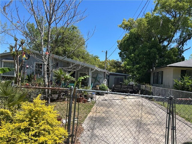 view of front of home with fence and a gate