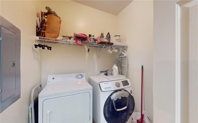 clothes washing area with electric panel and separate washer and dryer