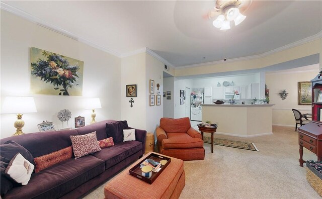 living room with ornamental molding, light carpet, and ceiling fan