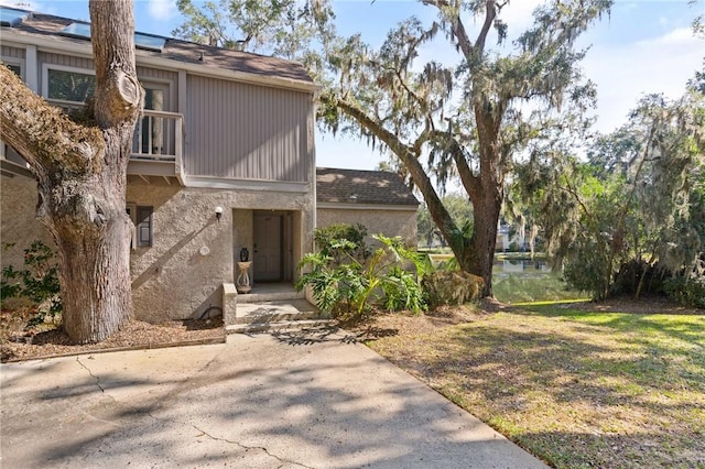 view of exterior entry featuring a yard