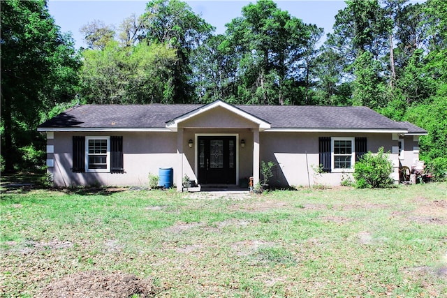 7535 Browntown Rd, Waynesville, GA 31566 - ranch-style home featuring a front lawn and stucco siding