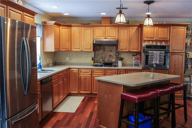 7535 Browntown Rd, Waynesville, GA 31566 - kitchen with appliances with stainless steel finishes, a sink, light countertops, ornamental molding, and dark wood finished floors