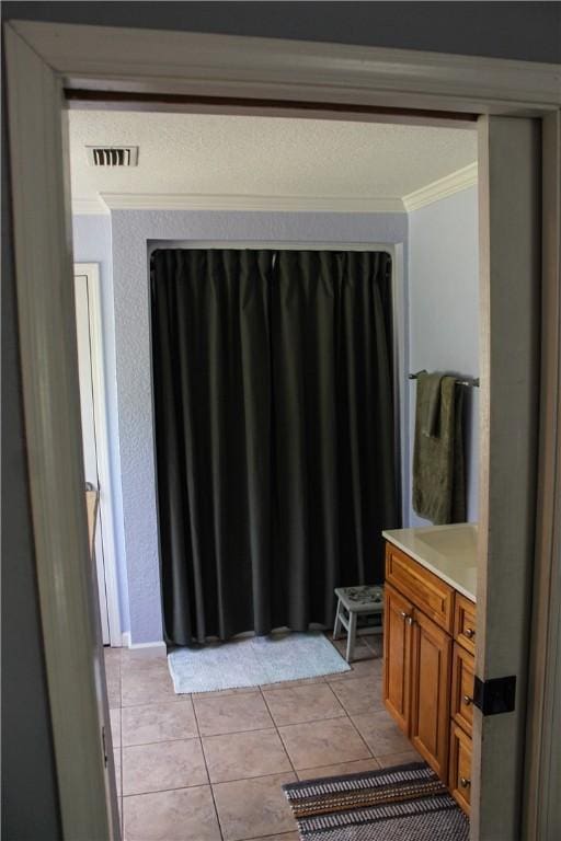 7535 Browntown Rd, Waynesville, GA 31566 - bathroom with crown molding, tile patterned flooring, and vanity