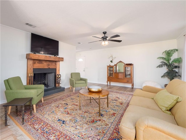 living room featuring hardwood / wood-style floors and ceiling fan