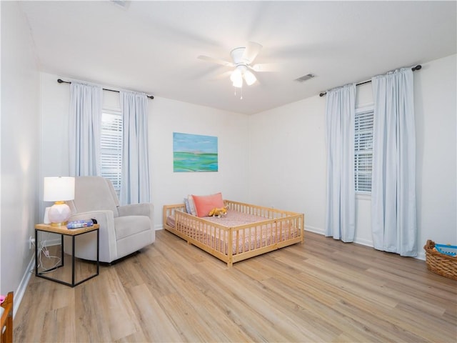 bedroom with ceiling fan and light hardwood / wood-style flooring