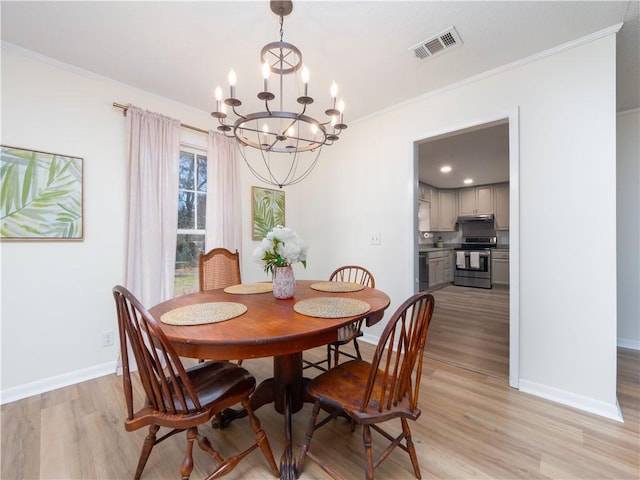 dining space featuring a notable chandelier, crown molding, and light hardwood / wood-style flooring