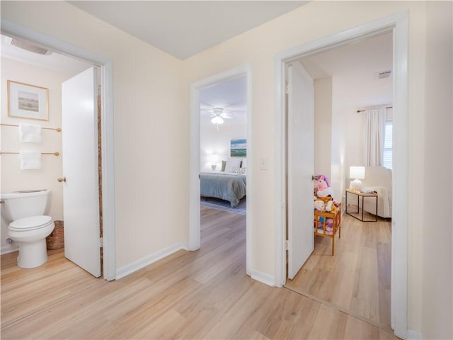 hallway with light hardwood / wood-style floors