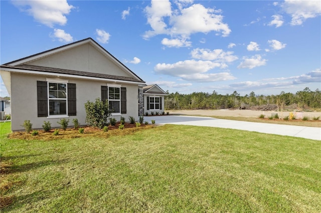 177 Verano St, Kingsland, GA 31548 - view of front facade with stucco siding, a front lawn, and driveway