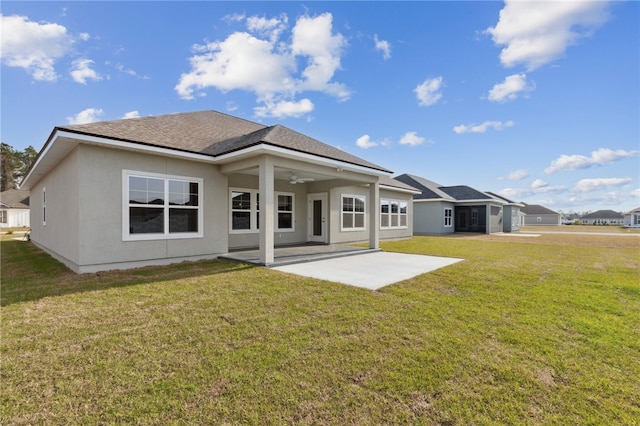 177 Verano St, Kingsland, GA 31548 - rear view of property featuring a patio area, a ceiling fan, a lawn, stucco siding, and roof with shingles