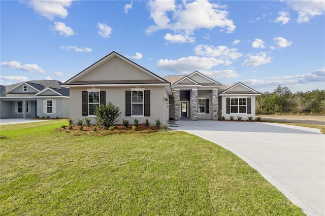 177 Verano St, Kingsland, GA 31548 - view of front of house with stucco siding, driveway, a front lawn, and stone siding