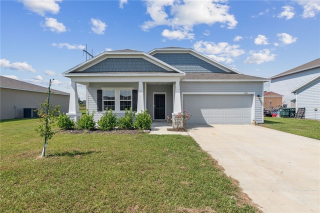 view of front of house with cooling unit, a front lawn, a porch, and a garage