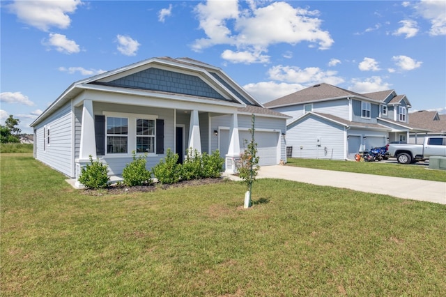 view of front of home with a porch, a garage, and a front lawn