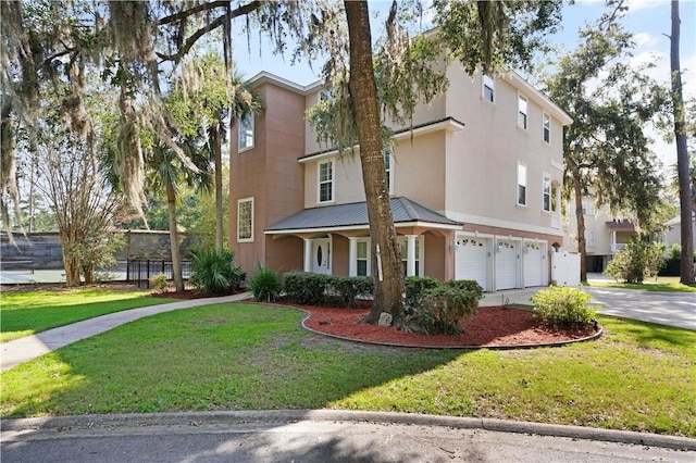 view of front of property featuring a front yard and a garage