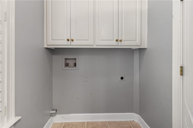 laundry room featuring hookup for an electric dryer, washer hookup, light tile patterned floors, and cabinets