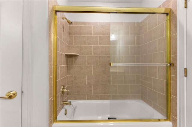 bathroom with bath / shower combo with glass door