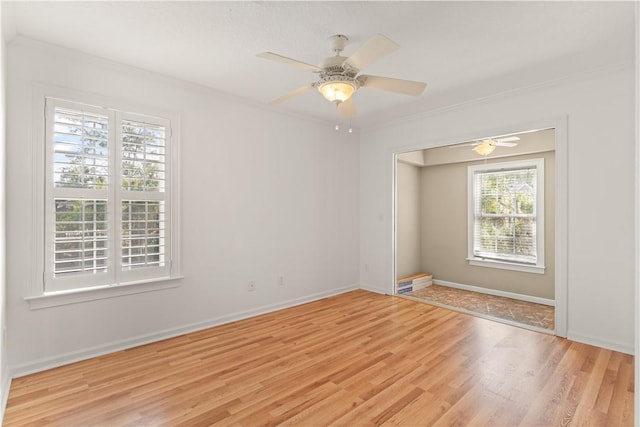 unfurnished room featuring ceiling fan, light hardwood / wood-style flooring, and ornamental molding