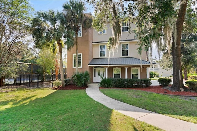 view of front of house featuring covered porch and a front lawn