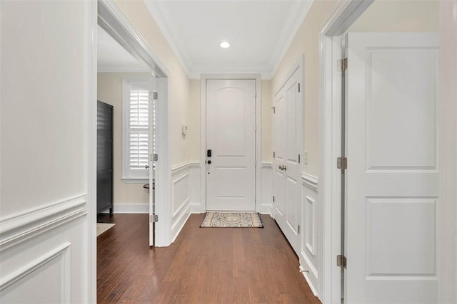 entryway featuring ornamental molding and dark wood-type flooring