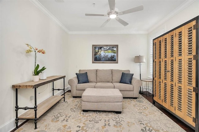 living room featuring ornamental molding, ceiling fan, and wood-type flooring