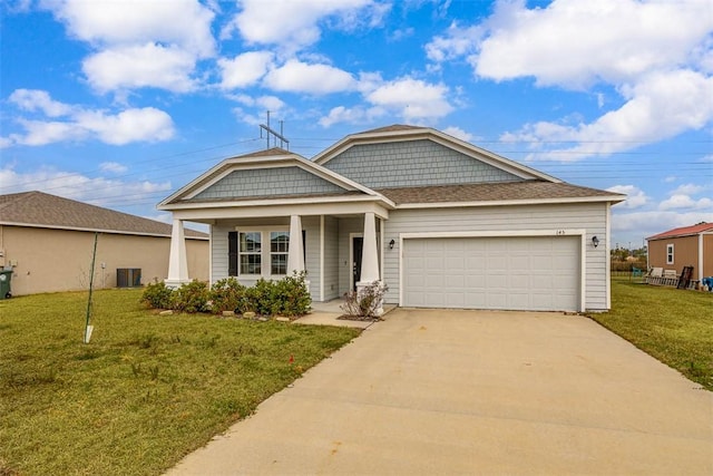 view of front of property featuring a garage and a front lawn