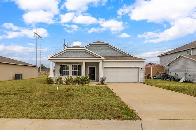 view of front of house with a garage, central AC, and a front lawn