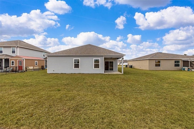 rear view of house featuring a yard