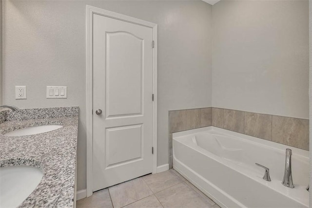 bathroom featuring vanity, tile patterned flooring, and a bathtub