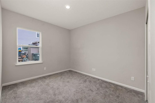 unfurnished room featuring carpet flooring