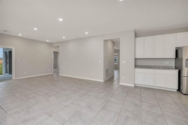 unfurnished living room featuring light tile patterned floors