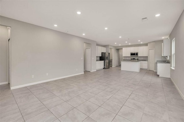 unfurnished living room with light tile patterned floors