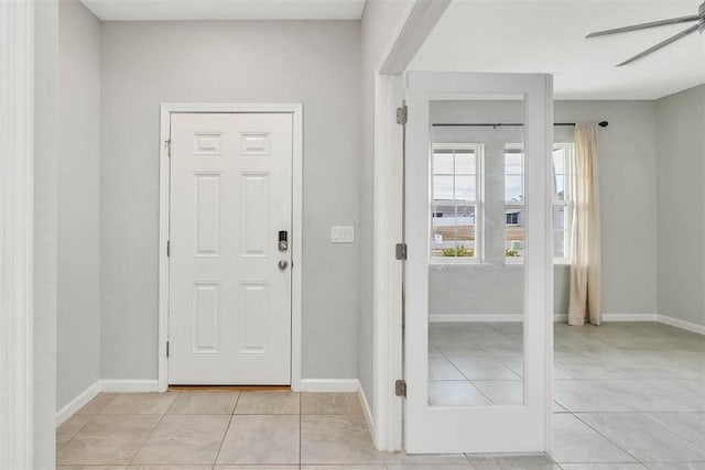 entrance foyer with light tile patterned floors and ceiling fan