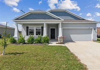 view of front of home featuring a garage and a front lawn