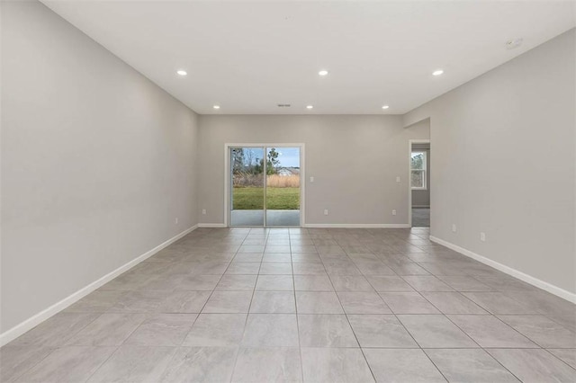 tiled empty room featuring a wealth of natural light