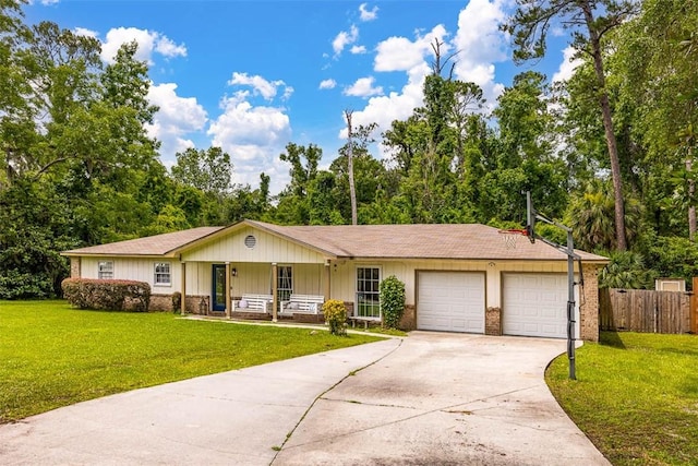 1201 Fairway Rd, Brunswick, GA 31525 - single story home with a porch, a garage, concrete driveway, view of scattered trees, and brick siding