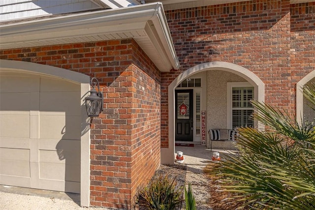 view of exterior entry with a garage