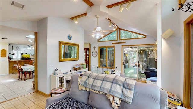 living area featuring ceiling fan, rail lighting, light tile patterned floors, and baseboards