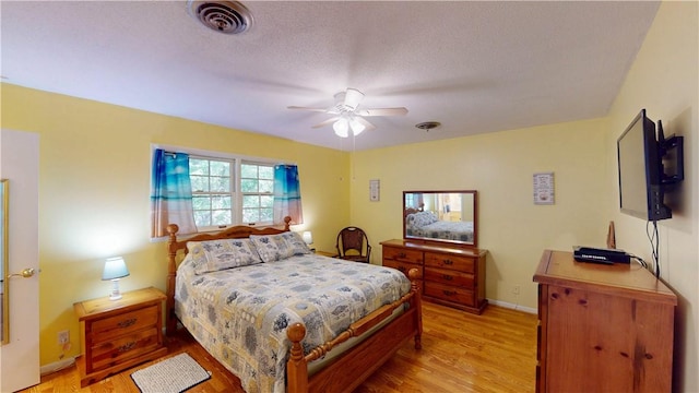 bedroom featuring light wood-style flooring, baseboards, and a ceiling fan