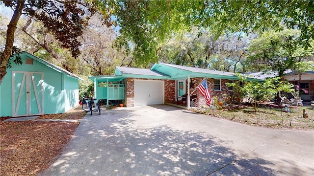 single story home with a garage, driveway, and brick siding