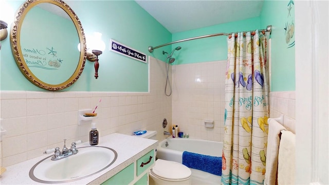 full bathroom with tile walls, shower / tub combo with curtain, toilet, and vanity