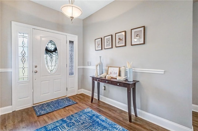 entryway with baseboards and wood finished floors