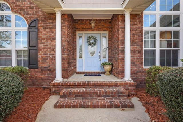 property entrance with brick siding