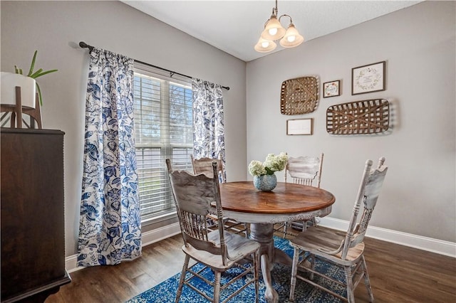 dining space with wood finished floors and baseboards