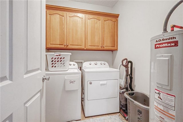 laundry room with light tile patterned floors, cabinet space, electric water heater, and washer and clothes dryer