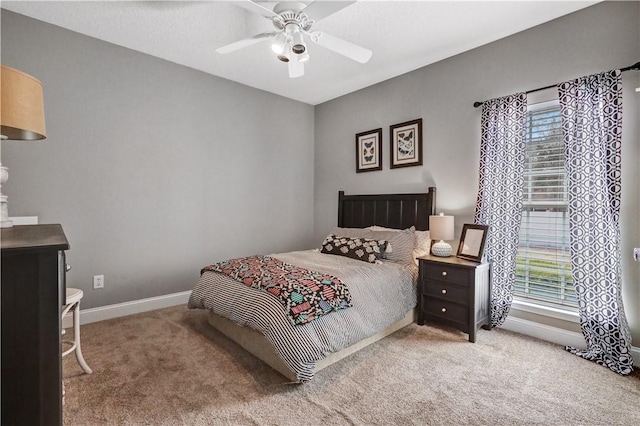 carpeted bedroom with baseboards and ceiling fan