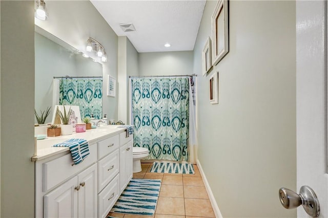 bathroom featuring tile patterned floors, visible vents, toilet, baseboards, and vanity