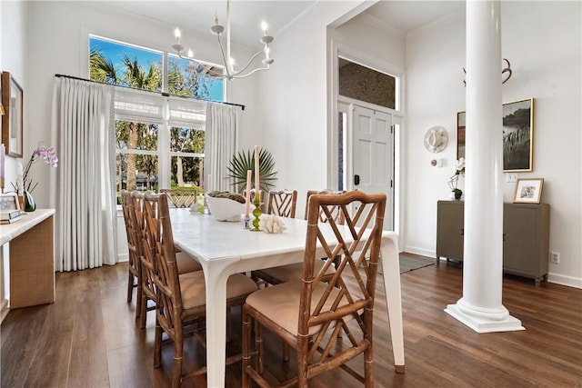 dining area featuring crown molding, ornate columns, dark wood-type flooring, and a high ceiling